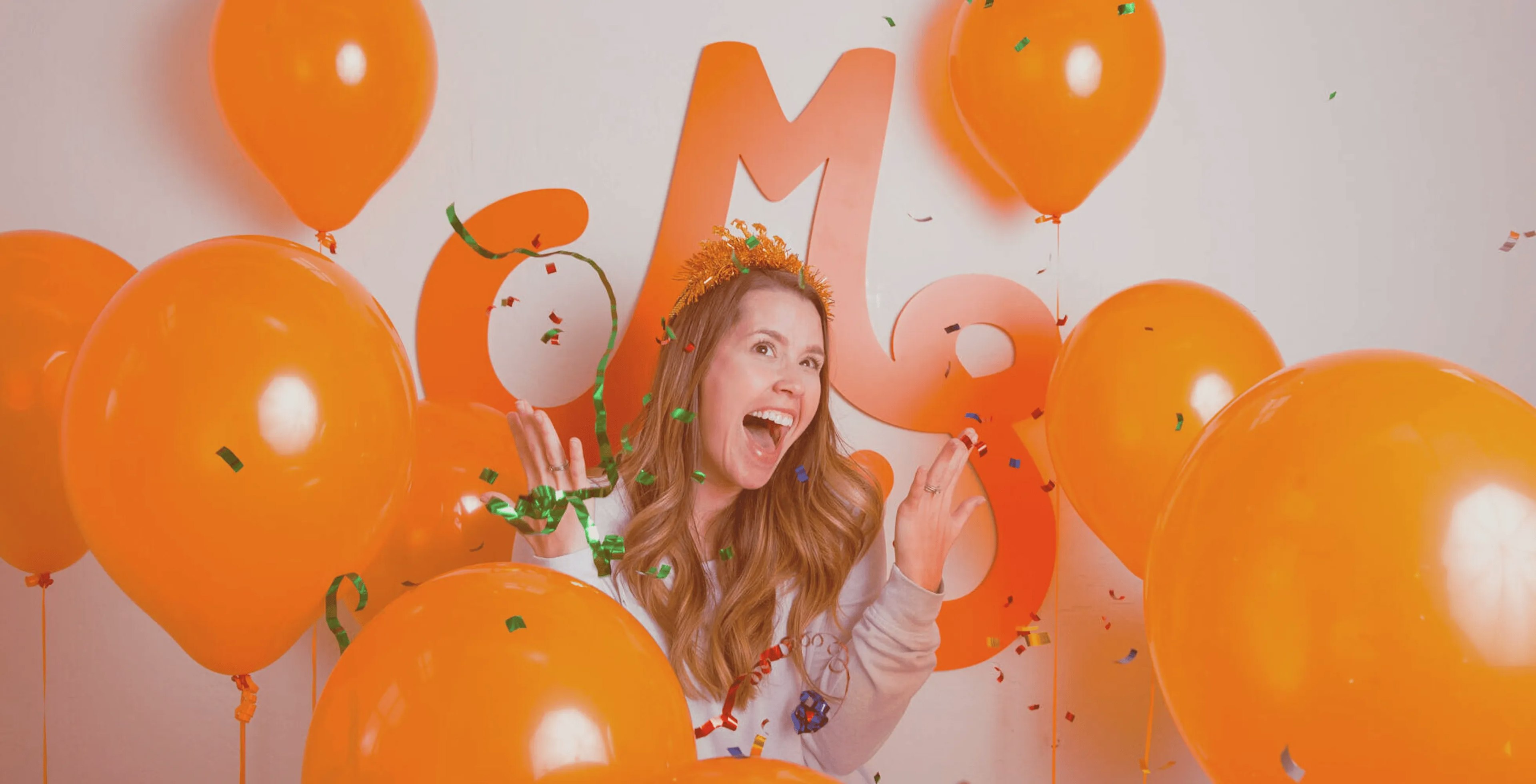 Mostly Serious team laughing and talking together around a conference table.