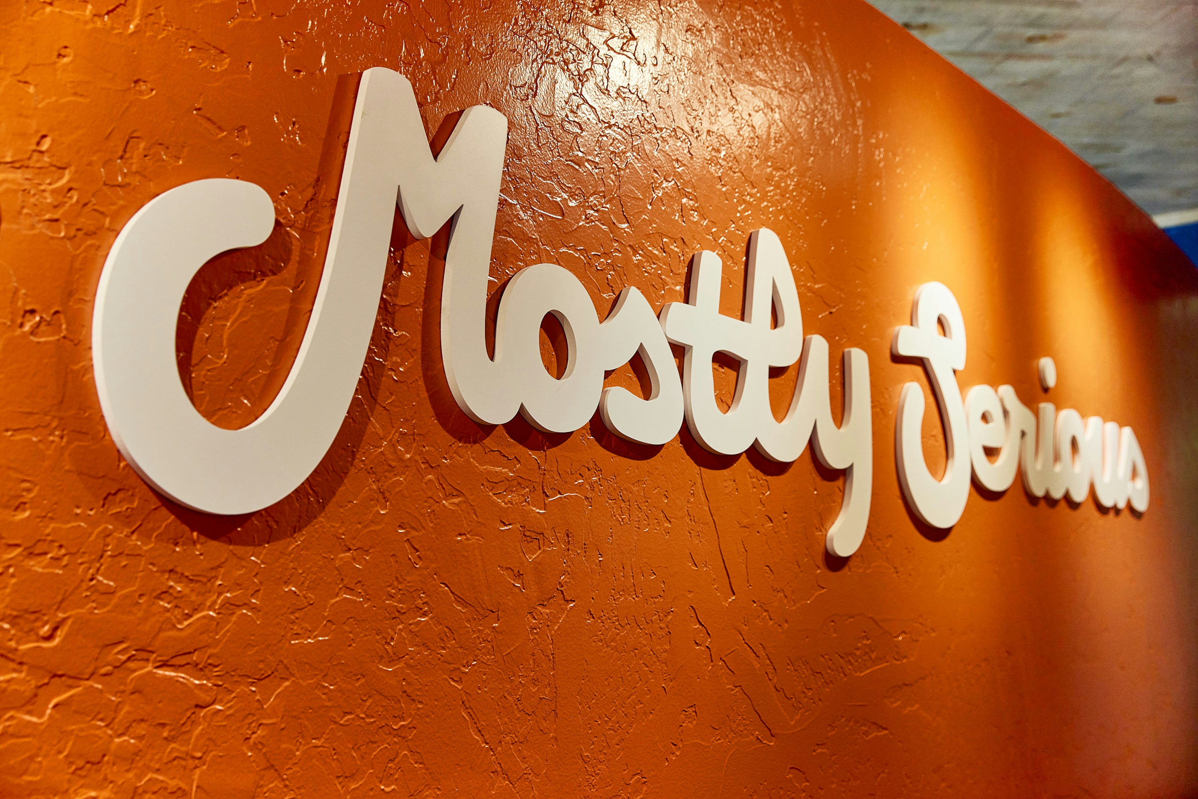 Mostly Serious mug reading “Let’s get to work.” on a desk.