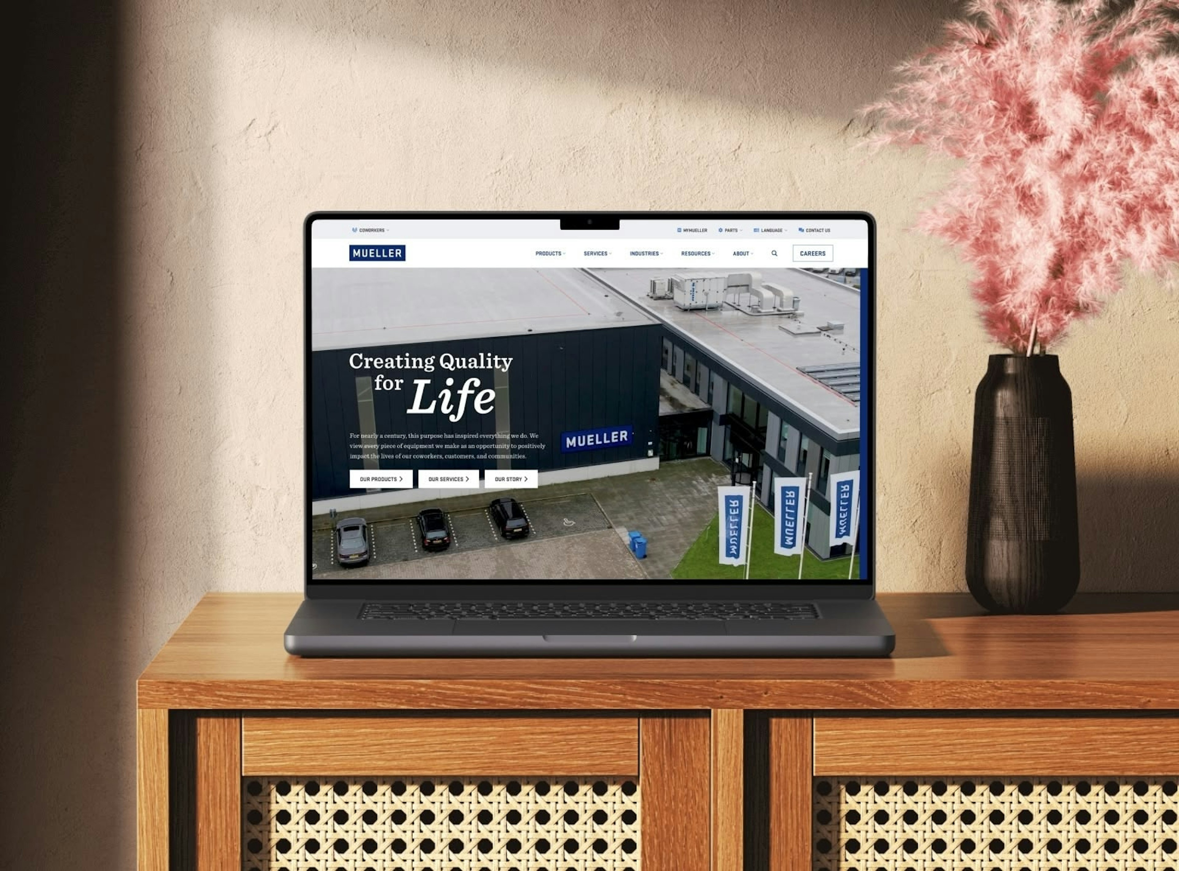 Paul Mueller Company website homepage displayed on a laptop, featuring their "Creating Quality for Life" tagline with an aerial view of their manufacturing facility and clean navigation design.